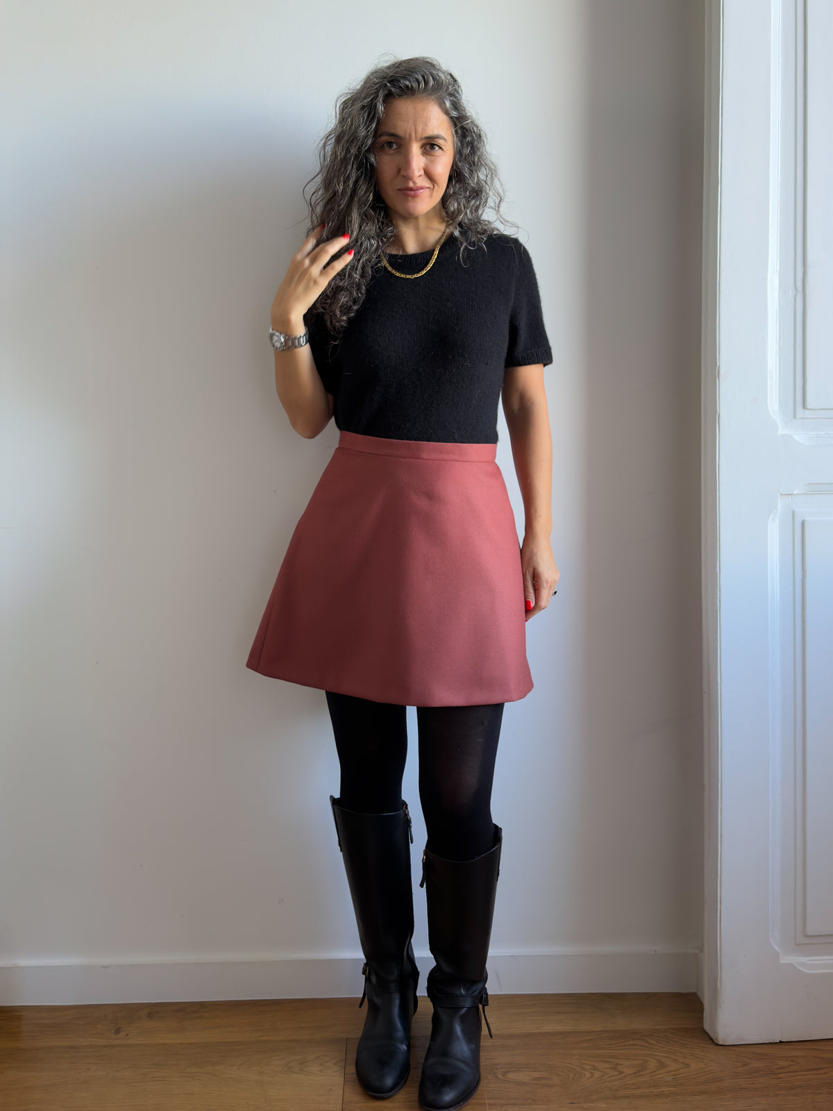 Karlie Skort sewing pattern, view A in the longer length in rust wool, front view with tights and boots