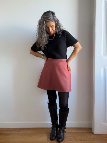 Karlie Skort sewing pattern, view A in the longer length in rust wool, hands on hips