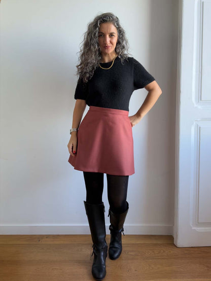 Karlie Skort sewing pattern, view A in the longer length in rust wool, hand on hip